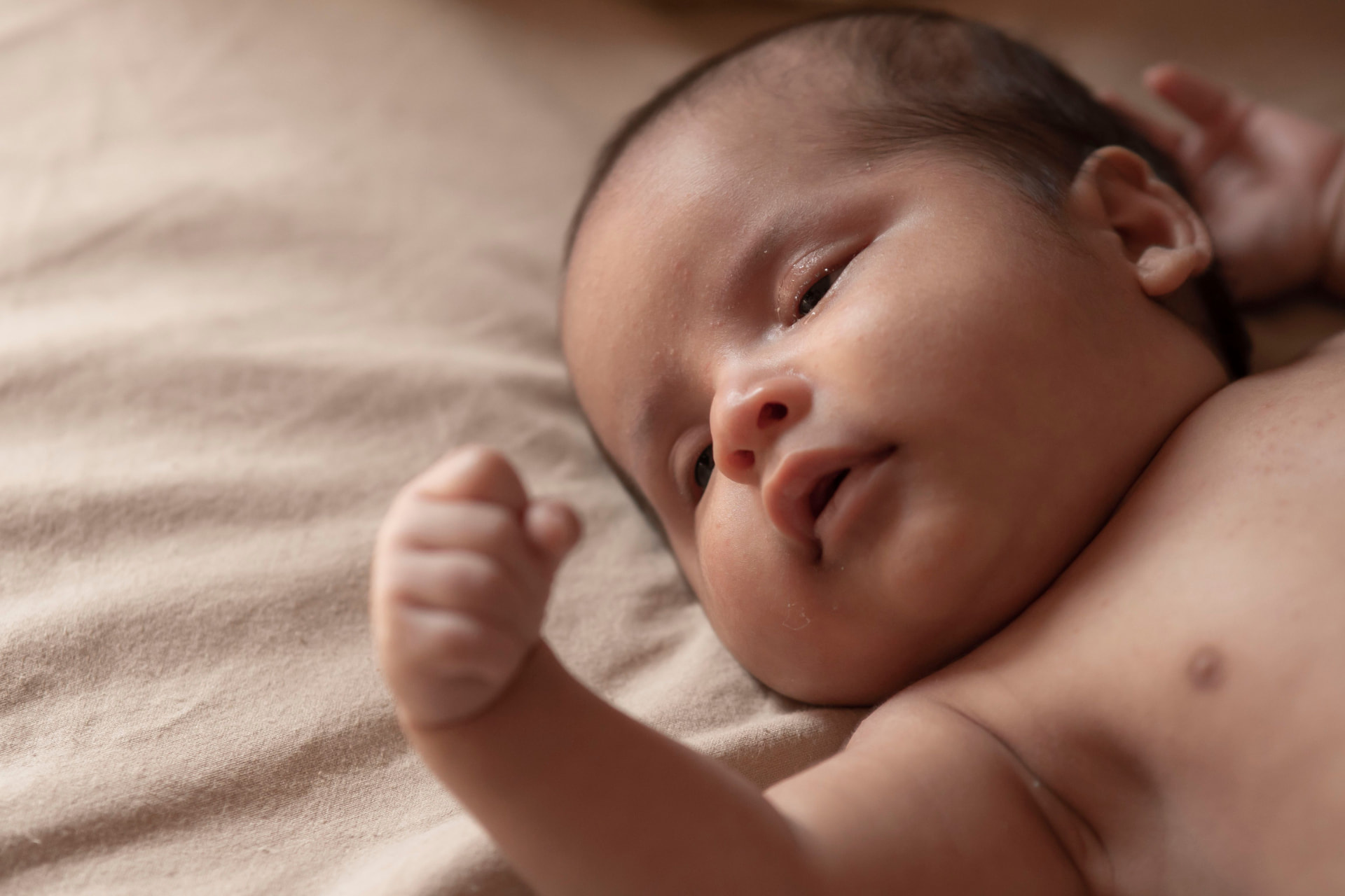 Calm newborn resting on a soft blanket